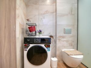 a washing machine in a bathroom next to a toilet at Villa Elusia in Kefalos +36 photos