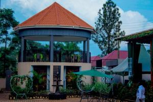 a gazebo with chairs and an umbrella at Spark Africa Hotel in Jinja +7 photos