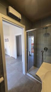 a bathroom with a shower and a glass door at Casa Vacanza Palazzo Monacelli 1 in Torre del Greco +35 photos