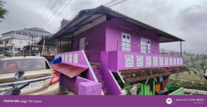 a purple house with a car parked in front of it at S K S HOME STAYs in Vālpārai