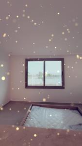 a room with a window and a swimming pool at Suite Ania in Imejoudene
