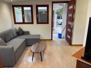 a living room with a couch and a table at Le Petit Pêcheur in Étang-Salé +8 photos