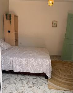 a bedroom with a bed and a wooden cabinet at Mama house in El Marsa