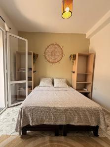 a bedroom with a bed and a mirror at Mama house in El Marsa