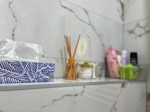 a shelf with a bunch of items on it at Stan na dan - SResidence Banja Luka in Banja Luka
