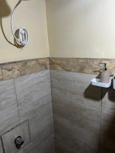 a bathroom with a shower with a sink at Rincón del río B&B in Ángeles