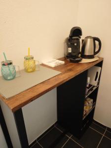 a counter with a coffee maker and a tea kettle on it at Monica Inn in Passau