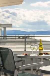 a table with two wine glasses and a bottle at The Harborvale, Autograph Collection in Burlington