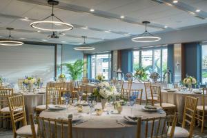 a set up banquet room with tables and chairs at The Harborvale, Autograph Collection in Burlington