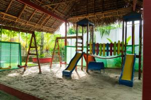 a playground with a swing set in a building at Los Gavilanes Hotel in Pucallpa