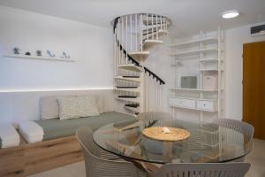 a dining room with a glass table and chairs at Sunny Apartment with Terrace in Ankaran