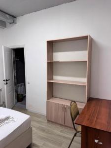 a bedroom with a desk and a bed and a desk and a chair at Хостел in Astana