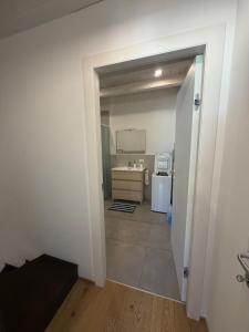 a view of a kitchen from the hallway of a apartment at Rovetta Tre Piazze Apartments in Brescia