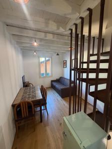 a living room with a table and a couch at Rovetta Tre Piazze Apartments in Brescia