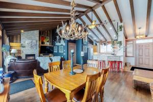 a dining room and living room with a wooden table and chairs at Tree Tops 15 in Big White
