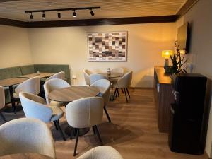 un ristorante con tavoli e sedie in una stanza di Pine Inn a Spilia