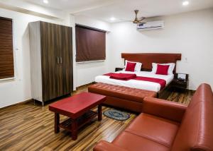 a hotel room with a bed and a couch at Sg Happy Stay in Machilīpatnam