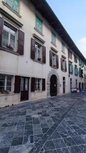 a white building with windows and a door at Affittacamere Borgo Antico in Venzone