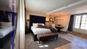 a bedroom with a bed and a table in it at Moulin Royale in Saint-Etienne-Roilaye