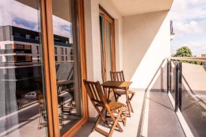 two chairs on the balcony of a apartment at Apartament 24 in Mysłowice