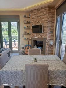 a dining room with a table and chairs and a fireplace at "Villa Kastania" Melidoni, Chania, Crete in Melidhónion
