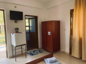 a living room with a refrigerator and a cabinet at Olive Nest Bunec in Sasaj