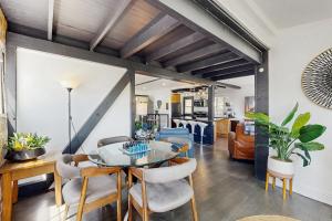 a dining room and living room with a table and chairs at The Polished Pine in Crestline