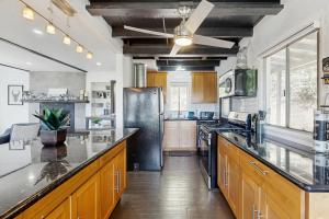 a large kitchen with wooden cabinets and a black refrigerator at The Polished Pine in Crestline