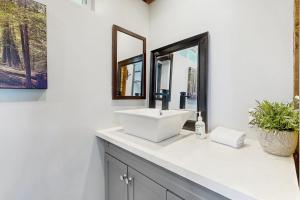 a white bathroom with a sink and two mirrors at The Polished Pine in Crestline +11 photos