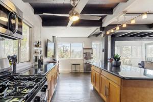 a large kitchen with wooden cabinets and a stove at The Polished Pine in Crestline