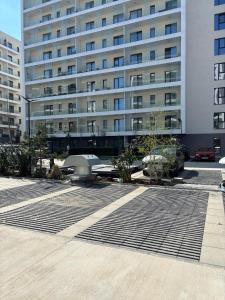 a large building with a grate in front of it at Oasis-First Estates Pipera in Voluntari