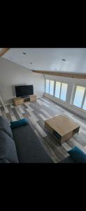 a living room with a couch and a coffee table at Maison de la passerelle in Parthenay