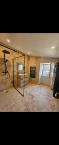 a living room with a tv and a mirror at Maison de la passerelle in Parthenay
