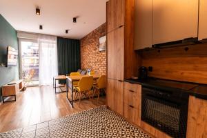 a living room with a table and a dining room at Apartament 24 in Mysłowice