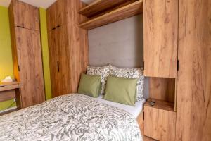 a bedroom with a bed with a wooden wall at Apartament 24 in Mysłowice