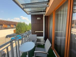 a balcony with a table and chairs on it at Nautica Residence in Balatonfüred
