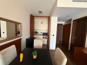 a living room with a table and chairs and a kitchen at Nautica Residence in Balatonfüred