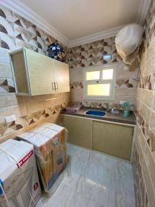 a kitchen with a counter and some boxes in a room at Adamora Stay in Marsa Alam City