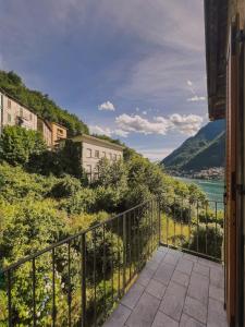 a balcony with a view of the water at Spacious 4BR Home with Lake View in Nesso