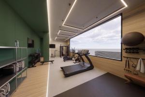 a gym with a large window and exercising equipment at Hospedium GL Hotel Andújar in Andújar