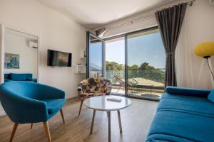 a living room with a blue couch and a table at Amfora-modern apartments with pool in Makarska