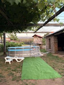 a play area with two chairs and a playground at Villa Tojo in Touro