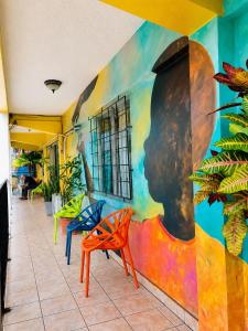 a wall with a painting of a woman on it at Hotel Miami CR in Puerto Limón +22 photos