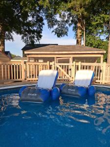 two chairs in the water in a swimming pool at Nijsha Enterprise in Jonesboro