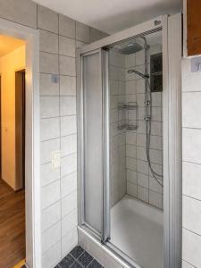 a shower with a glass door in a bathroom at Ferienwohnung Bergpanorama Waldweg in Altmünster