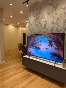 an office with a large screen tv on a table at Tirana Lake Bliss Apartment in Sauk