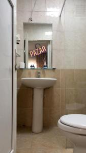 a bathroom with a sink and a toilet and a sign at Kenedi Otel in Altındağ