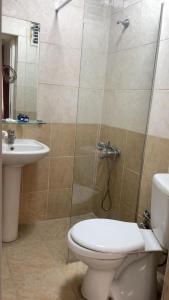 a bathroom with a shower and a toilet and a sink at Kenedi Otel in Altındağ +8 photos