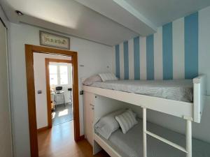 a bedroom with two bunk beds and a hallway at Atico en el centro de Vitoria Parking gratis in Vitoria-Gasteiz