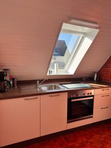 a kitchen with a sink and a window at Ferienwohnung Klahn Neue Tiefe in Neue Tiefe Fehmarn